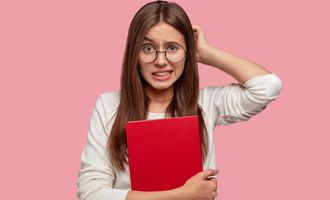 Stressed and uncertain teenage girl is having an oral exam