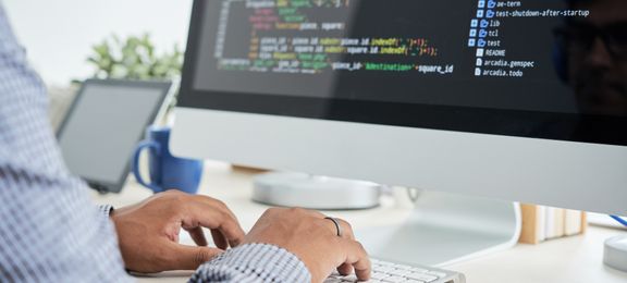 Man coding on his computer