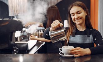 Young barista making coffee