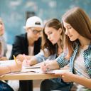 Group of students at high school doing homework in class